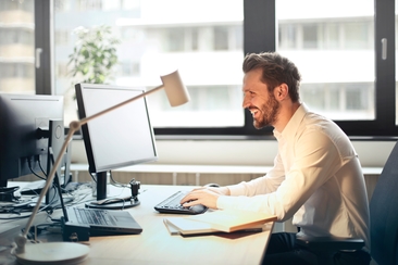 Person using computer to search for GIS Salary and Job Outlook