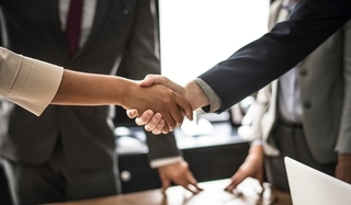 Two GIS professionals shaking hands